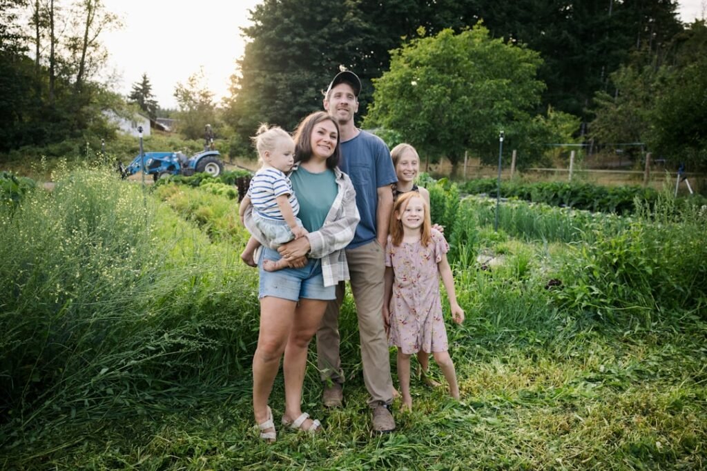 Family enjoying time together in a lush green farm setting, representing urban professionals embracing weekend farming lifestyle