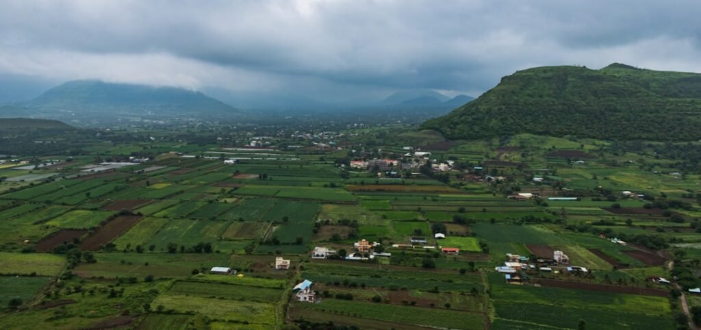 Panoramic view of green agricultural fields and rural landscape in Maharashtra, India - representing managed farmland opportunities near Bangalore